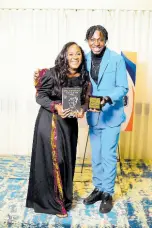  ?? PHOTO BY PAUL WILLIAMS ?? Christophe­r Campbell being presented with his Jamaican Kingdom Indie Author Award by Crystal Daye for winning the teen/ young adult category for his  rst novel, ‘The Ambitious Woman of the West’.