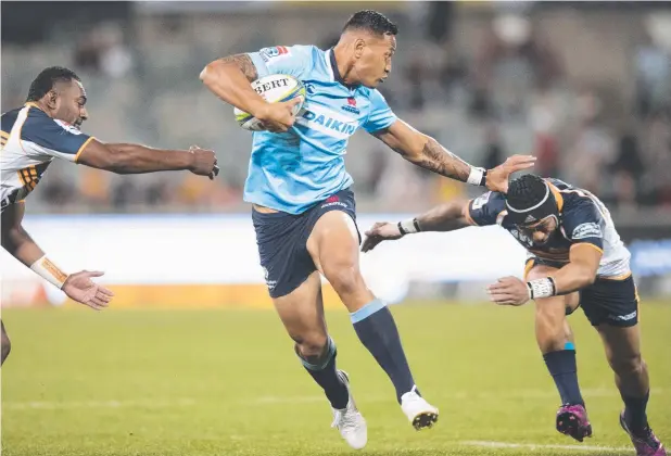  ?? Picture: AAP IMAGE ?? SIDELINED: Israel Folau of the Waratahs fends off a Brumbies tackle in Canberra on Saturday before suffering a hamstring injury.