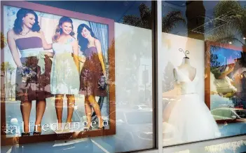  ?? THE ASSOCIATED PRESS ?? A window display is seen at Alfredo Angelo bridal store in West Covina, Calif., in July. Florida-based bridal retailer Alfred Angelo shuttered its 60 U.S. stores and filed for Chapter 7 bankruptcy liquidatio­n in July, leaving brides-to-be around the...