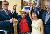  ?? TOM REEL / SAN ANTONIO EXPRESS-NEWS ?? Pete Flores raises his hands in victory Tuesday along with Lt. Gov. Dan Patrick (left) and GOP Chairman James Dickey to celebrate Flores’ Senate District 19 special election win in San Antonio. State Sen. Donna Campbell is in front.