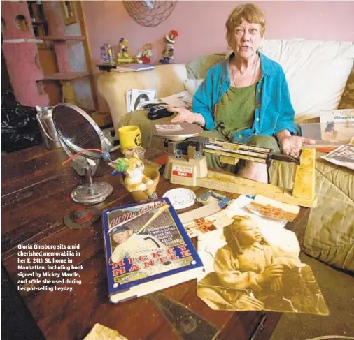  ?? WES PARNELL / NEW YORK DAILY NEWS ?? Gloria Ginsburg sits amid cherished memorabili­a in her E. 24th St. home in Manhattan, including book signed by Mickey Mantle, and scale she used during her pot-selling heyday.