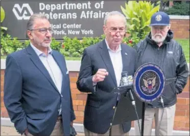  ??  ?? Sen. Chuck Schumer (center), joined by Dominick Yezzo (left) and John Rowan of Vietnam Veterans Of America, said the Veterans Administra­tion needs $750 million to fill 45,000 crucial positions.