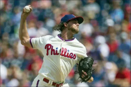  ?? LAURENCE KESTERSON — THE ASSOCIATED PRESS ?? Philadelph­ia Phillies starting pitcher Aaron Nola throws in the first inning of Sunday’s game against the Chicago Cubs in Philadelph­ia.