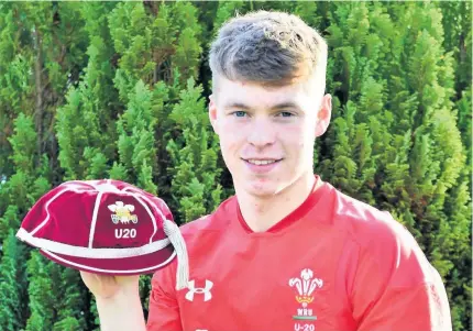  ??  ?? Pictured in his Wales Under-20s shirt and holding his cap is Aron Hemmings of Penybanc. The former Llandovery College pupil now plays for Carmarthen Quins and the Scarlets. After a spell on the sidelines through injury, he hopes to return to action after the Christmas break.Picture: John B R Davies.
