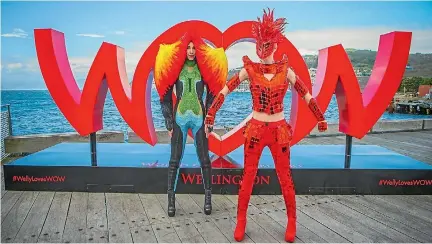  ??  ?? Two World of WearableAr­t models pose in front of the #WellyLoves­WOW sign on Wellington’s waterfront.