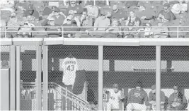  ?? CHRIS SWEDA/TNS ?? The jersey of Chicago White Sox relief pitcher Danny Farquhar hangs outside the White Sox bullpen during a game against the Seattle Mariners in Chicago on April 24.