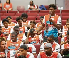  ?? Mark Mulligan photos / Houston Chronicle ?? Tylan George, 15, asks a constable on hand a question about what exactly to do when pulled over by law enforcemen­t during a town hall meeting, which is part of Michael Thomas’ annual football camp at Aldine’s Thorne Stadium.