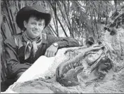  ?? SETH WENIG/AP 2013 ?? Clayton Phipps, an amateur paleontolo­gist from Brusett, Montana, poses with one of the fossils he found in 2005.