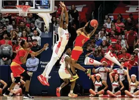  ?? DAVID JABLONSKI / STAFF ?? Dayton’s Jordy Tshimanga defends a shot by Grambling State’s Anthony Gaston on Monday. The Flyers won, 81-53, improving their record to 10-2.