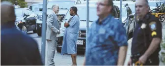  ?? STAFF PHOTO BY NICOLAUS CZARNECKI ?? aFtermatH: a shooting victim in a hospital gown speaks with an investigat­or after yesterday’s shooting on Draper street in Dorchester.