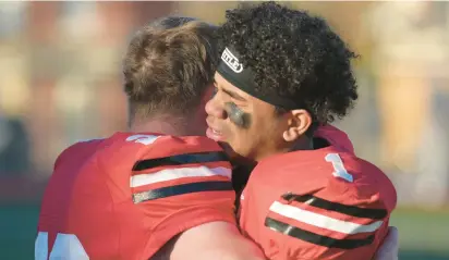  ?? RICK KINTZEL/THE MORNING CALL ?? Parkland’s Joseph Trestrail, left, embraces teammate Victor Page on Saturday after losing 52-21 to St. Joe’s Prep in the PIAA Class 6A quarterfin­als at Bethlehem Area School District Stadium.