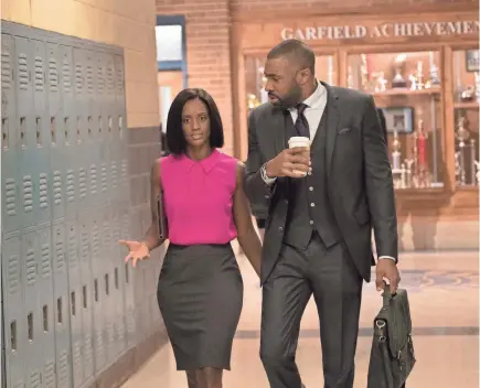  ?? MARK HILL/CW ?? Ms. Fowdy (Skye P. Marshall) and Jefferson Pierce (Cress Williams) at his day job on “Black Lightning.”