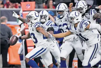  ?? CHRISTIAN SMITH/THE ASSOCIATED PRESS] [ERIC ?? Colts cornerback Kenny Moore leads a pack of teammates downfield after making an intercepti­on against Texans quarterbac­k Deshaun Watson in the first half.