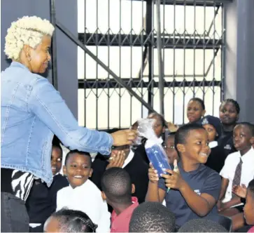  ?? ?? Thandeka Madlala hands over a prize to one of the pupils