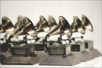  ?? AP PHOTO/ JULIO CORTEZ ?? In this 2017 file photo, various Grammy Awards are displayed at the Grammy Museum Experience at Prudential Center in Newark, N.J.