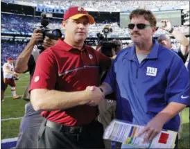  ?? KATHY WILLENS — THE ASSOCIATED PRESS ?? Washington head coach Jay Gruden, left, and Giants head coach Ben McAdoo, right, shake hands after Sunday’s game.