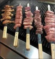  ?? MICHELLE KUCINICH ?? Nick Kustala’s take on a Brazilian grill offers meats grilled on a sword.