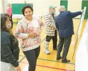  ?? GARY GIBULA/PIONEER PRESS ?? Elmwood Park residents Jenny Gonzales, left, and Mayra Gallegos view grade crossing alternativ­es displayed at a public informatio­n meeting May 24 in Elmwood Park.