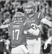  ?? AP/SEAN RAYFORD ?? South Carolina kicker Parker White celebrates with teammate Danny Gordon (17) after kicking a 31-yard field goal with 4 seconds remaining Saturday that gave the Gamecocks a 17-16 victory over Louisiana Tech in Columbia, S.C.