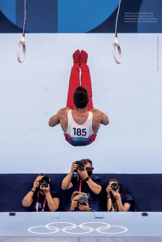  ?? ?? Turkish gymnast Ibrahim Colak dismounts the rings in front of photograph­ers during a qualifying round at the Tokyo 2020 Olympics.