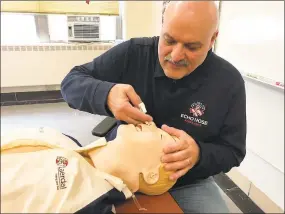  ?? Brian Gioiele / Hearst Connecticu­t Media ?? Patrick Lahaza, education and paramedic coordinato­r at Echo Hose Ambulance Corps in Shelton, demonstrat­es the proper use of Narcan nasal spray to reverse an overdose.