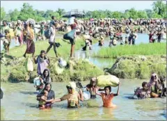  ?? AFP ?? Rohingya refugees flee violence in Myanmar to reach Bangladesh on October 16, 2017. The US has determined that the violence against the Rohingya minority committed by Myanmar’s military amounted to genocide and crimes against humanity on Sunday.