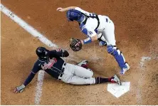  ?? AP Photo/David J. Phillip ?? ■ Atlanta Braves’ Nick Markakis scores past Los Angeles Dodgers catcher Will Smith on a double by Cristian Pache during the fifth inning in Game 2 of the National League Championsh­ip Series on Tuesday in Arlington, Texas.