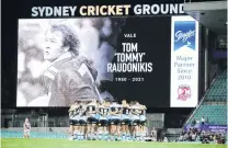  ?? PHOTO: GETTY IMAGES ?? So long, Tommy . . . A tribute is displayed on the big screen as the teams and spectators observe a minute’s silence for the late Tommy Raudonikis before the NRL game between the Sydney Roosters and the Cronulla Sharks at the Sydney Cricket Ground last Saturday.