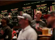  ?? AP PHOTO ?? In this March 22, 2013, file photo, odds for second-round NCAA basketball tournament games are displayed on a board at the Mirage hotel-casino Race & Sports Book in Las Vegas.