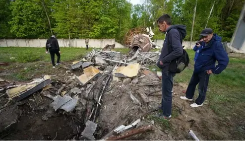  ?? ?? People look at fragments of the television tower which was broken in half after it was hit by a Russian missile in Kharkiv, Ukraine, Monday, April 22, 2024.