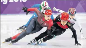  ?? THE CANADIAN PRESS/NATHAN DENETTE ?? Valerie Maltais, left, of Canada, competes as she tries to catch Chunyu Qu, right, of China, in the women’s 3,000m short track speed skating relay during the 2018 Olympic Winter Games in Gangneung, South Korea, Tuesday.