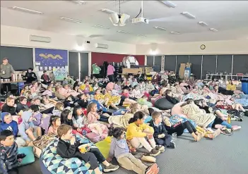  ??  ?? The St Michael’s students getting comfortabl­e in their sleeping bags at the movie night last Friday.