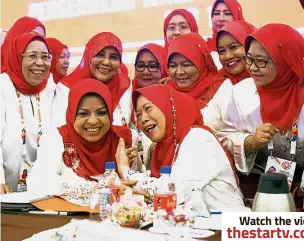  ?? — Bernama ?? Light moment: Shahrizat (seated, left) listening to her deputy Datuk Azizah Mohd Dun as the wing’s members share in the amusement at the PWTC.