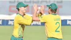  ?? - AFP photo ?? South Africa’s George Linde (left) celebrates with teammate South Africa’s Wihan Lubbe after the dismissal of Pakistan’s Haider Ali (not visible) during the second Twenty20 internatio­nal cricket match between South Africa and Pakistan on Monday.