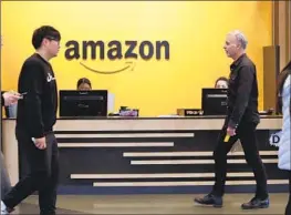  ?? Elaine Thompson Associated Press ?? AWS CUSTOMERS will be able to access Hugging Face AI tools through Amazon’s SageMaker program. Financial details of the partnershi­p were not disclosed.