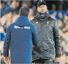  ?? Photo / AP ?? Liverpool manager Juergen Klopp shows his disappoint­ment as he shakes hands with Everton coach Marco Silva after the goalless draw.