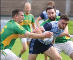  ?? ?? Lawrence Mckeown is tackled by Tiarnán Daly and Liam Mcquaid during the Division Two final.