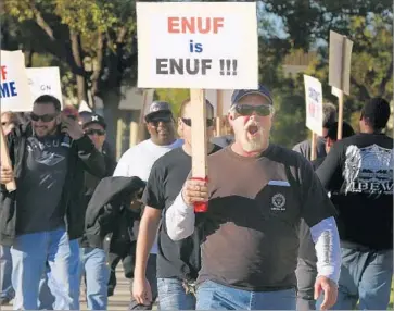  ?? Mark Boster Los Angeles Times ?? MEMBERS OF the Internatio­nal Brotherhoo­d of Electrical Workers protest layoffs by Southern California Edison in 2015. Edison said at the time that it was “not hiring H-1B workers to replace displaced employees.”