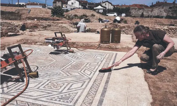  ?? Picture: AFP ?? An archaeolog­ist works on a mosaic at Sainte-Colombe, near Vienne, eastern France, where the remains of a Roman city have been uncovered.