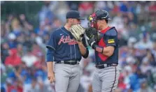  ?? AP PHOTO/CHARLES REX ARBOGAST ?? Atlanta Braves starting pitcher Bryce Elder, left, talks with catcher Sean Murphy after he walked the first two batters he faced in Saturday’s game against the host Chicago Cubs.