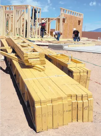  ?? GREG SORBER/JOURNAL ?? Lumber prices are driving up the prices of new homes nationwide, thanks to a tariff on Canadian softwood lumber, and posing a challenge for many builders. A pile of framing lumber lies at a constructi­on site at a D.R. Horton subdivisio­n near Paseo del Norte and Universe NW.