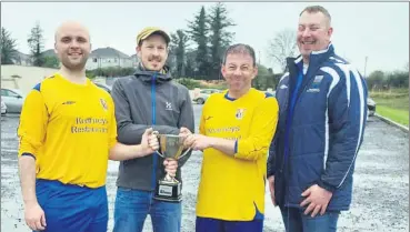  ?? ?? Brideview Utd B captians Andy O’Riordan and Stephen Pratt, accepting The Avondhu First Division trophy from sponsor Kevin Howard ‘The Avondhu’ newspaper. Also present is chairman of the WW/EC Junior League, Sean Sheehan.