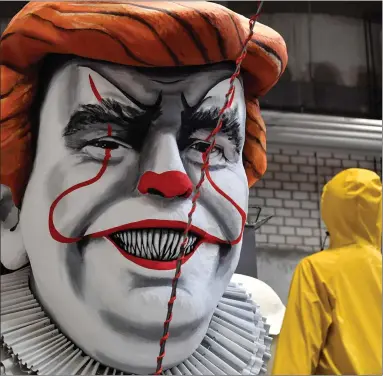  ??  ?? A satiric carnival float depicting US President Donald Trump as horror clown Pennywise in Cologne, Germany. The traditiona­l carnival parades in the city make fun of politics and are watched by hundreds of thousands Picture: AP Photo/martin Meissner