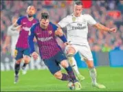  ?? AFP ?? Real Madrid midfielder Lucas Vazquez (right) vies for the ball with Barcelona's Lionel Messi during their Copa del Rey semi-final.