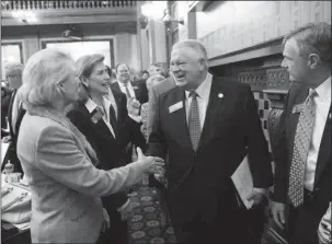  ?? The Associated Press ?? PROPOSED SHIFTS: Georgia House Speaker David Ralston, center, is greeted on the House floor Jan. 9 on the first day of the legislativ­e session in Atlanta. In 2017, Georgia Republican­s sought to change the boundaries of several state House districts,...