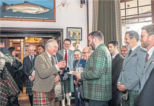  ??  ?? ‘CHAMPIONS LOCAL HERITAGE’: The Duke of Rothesay enjoys a dram with other guests during the reopening of the Fife Arms in Braemar