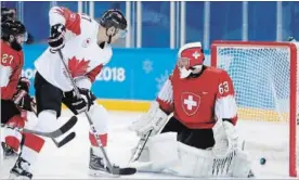  ?? JULIO CORTEZ THE ASSOCIATED PRESS ?? Rene Bourque scored on Canada’s first shot on Swiss goalie Leonardo Genoni on Thursday, before helping chase him out of the net in the second with his second goal here in 5-1 win.