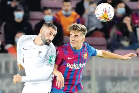  ?? AFP ?? Granada’s midfielder MaximeGona­lons (left) vies with Barcelona’s midfielder Gavi during the Spanish League football match on Monday.