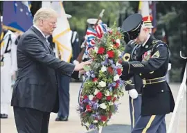  ?? Evan Vucci Associated Press ?? PRESIDENT TRUMP lays a wreath at the Tomb of the Unknown Soldier at Arlington National Cemetery. His Memorial Day was not without controvers­y.