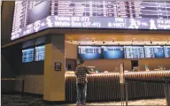  ?? Wayne Parry / Associated Press ?? A customer ponders the odds at the sportsbook at Bally's casino in Atlantic City, N.J.